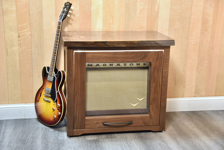 Walnut Amp Cabinet closed with a Magnatone amplifier inside and a Gibson guitar leaning against it
