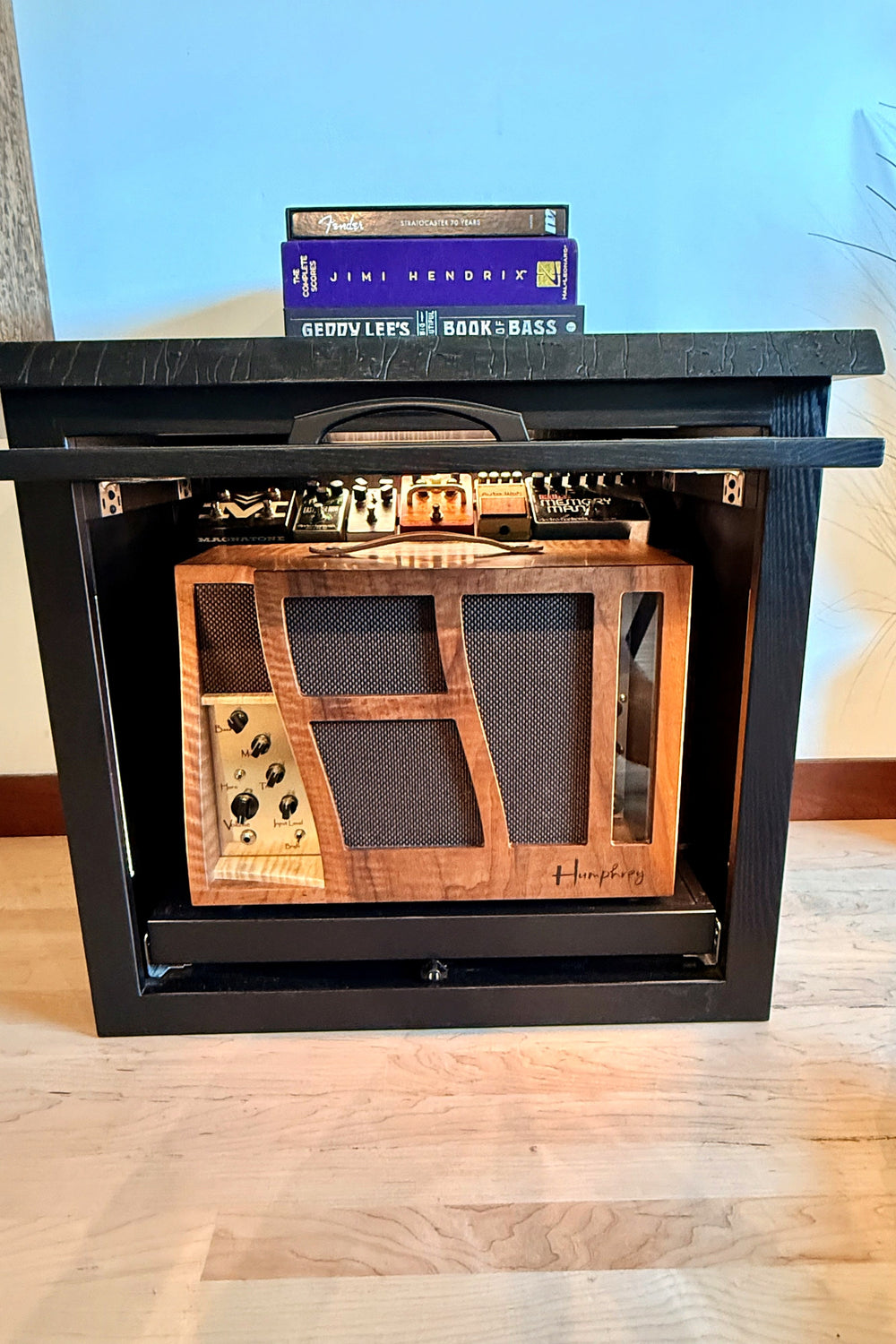 Amp Cabinet with the door open and the amplifier lit on its roll-out shelf