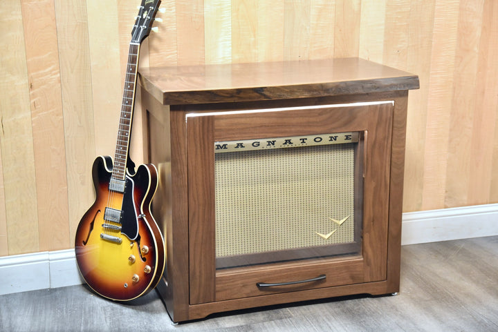 Walnut Amp Cabinet in a room setting with a guitar leaning against it