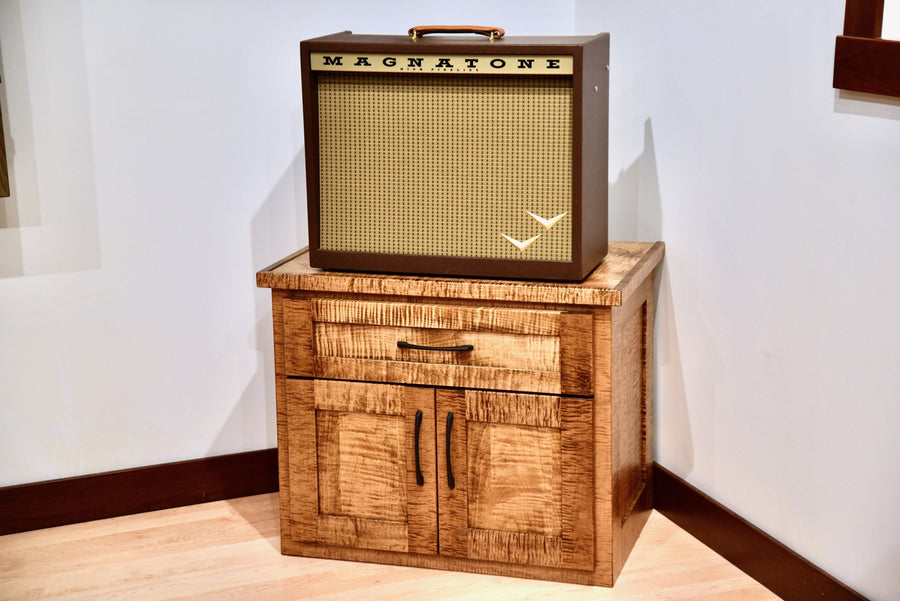 Flamed maple Amp Stand with a Magnatone amplifier sitting on top and doors closed