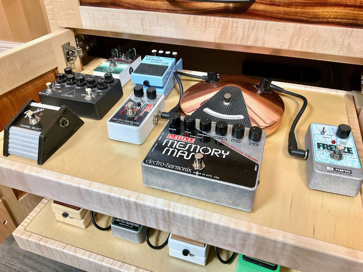 Close detail of effects pedals on the Amp Stand shelf