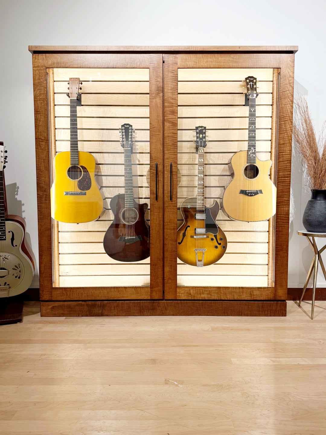Low Depth ClimaCab V in flame maple, front view with five guitars