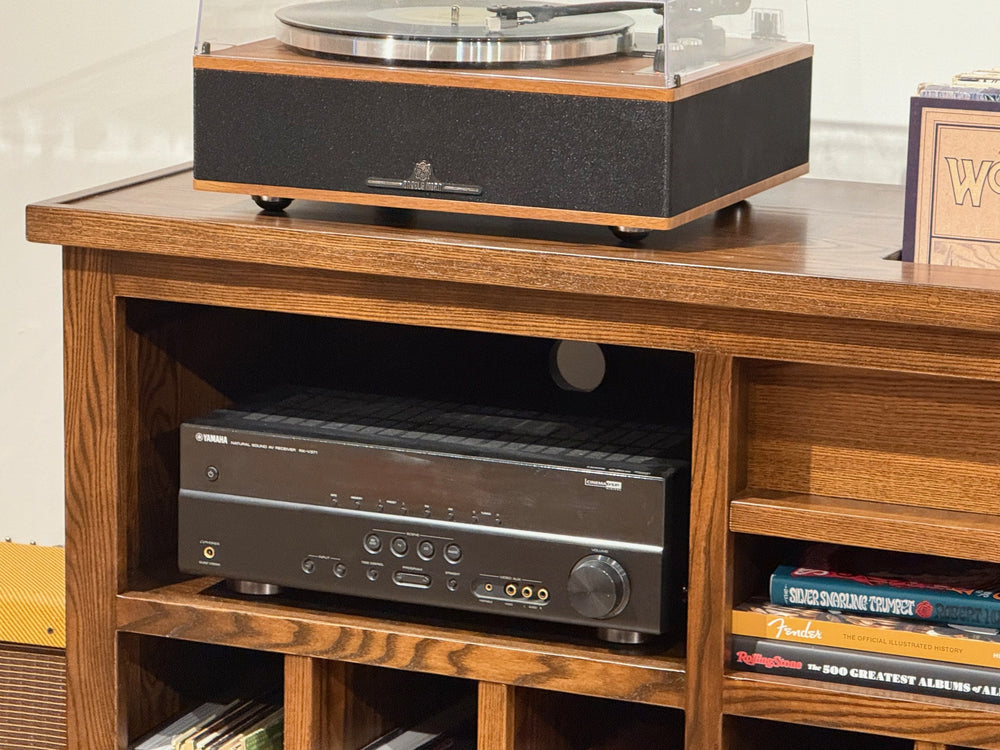 Record Console seen from the front with a receiver in the open component bay and records filed upright below