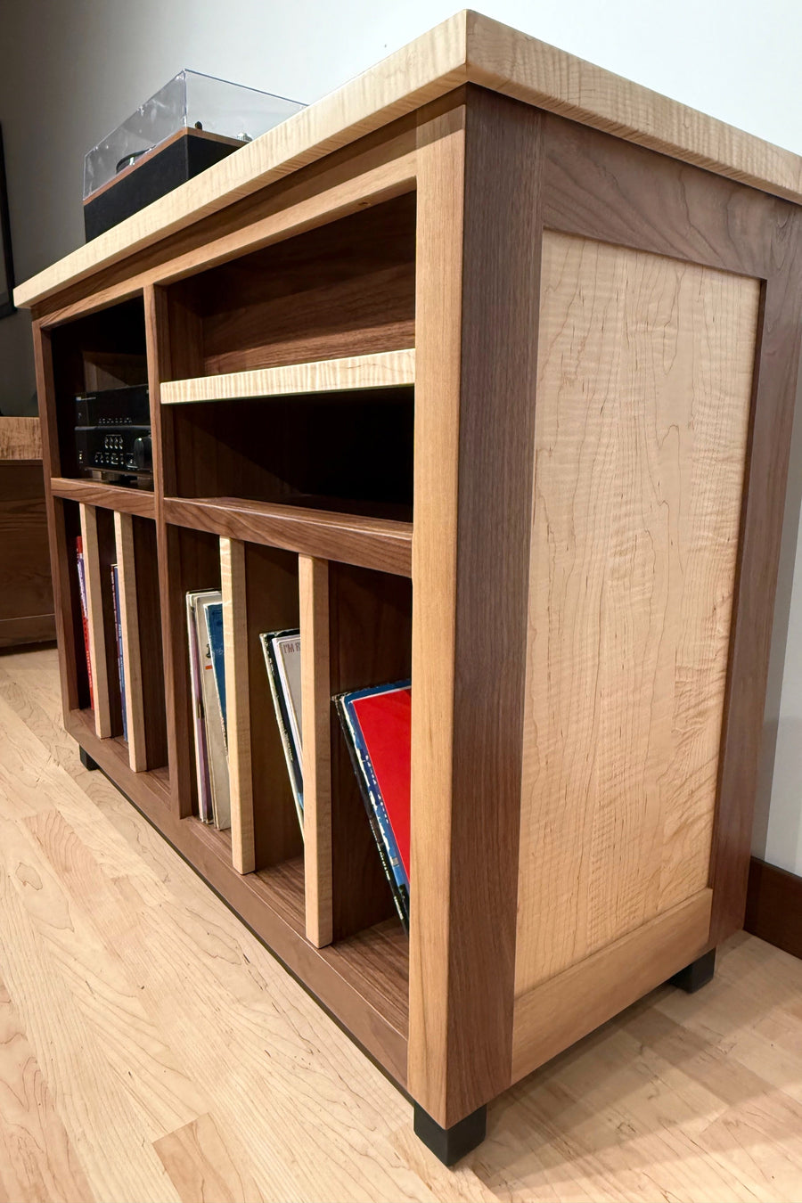 Record Console in figured maple and walnut with records filed upright behind hardwood dividers