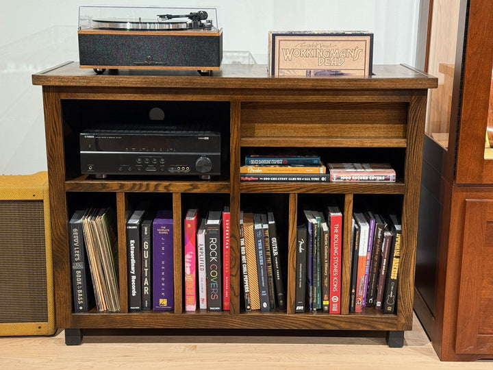Front view of the ash Record Console with books and records filed in the lower bays
