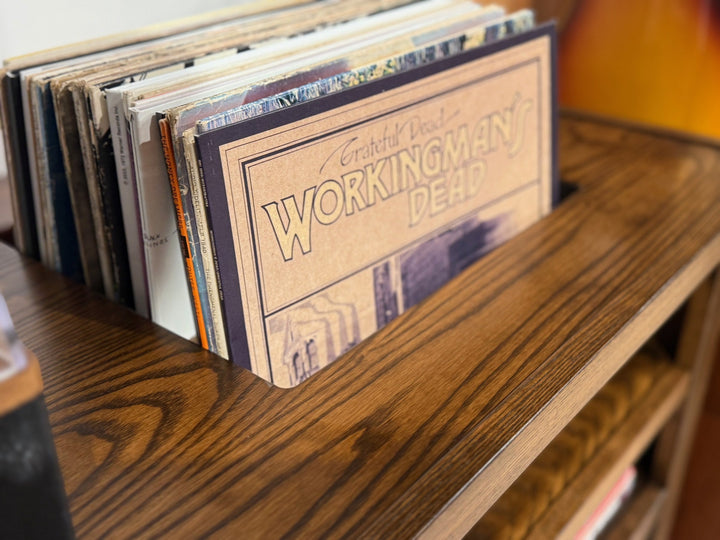 Album covers standing in the slot cut into the top of the ash console