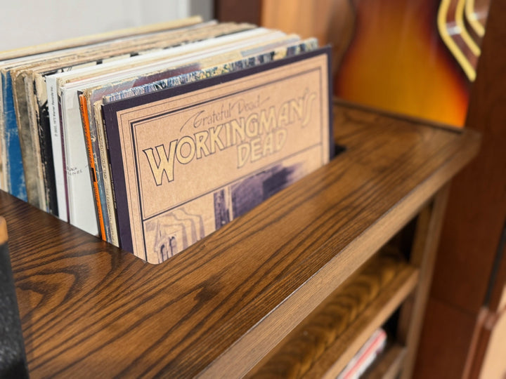 Close view of records standing upright in the console top slot