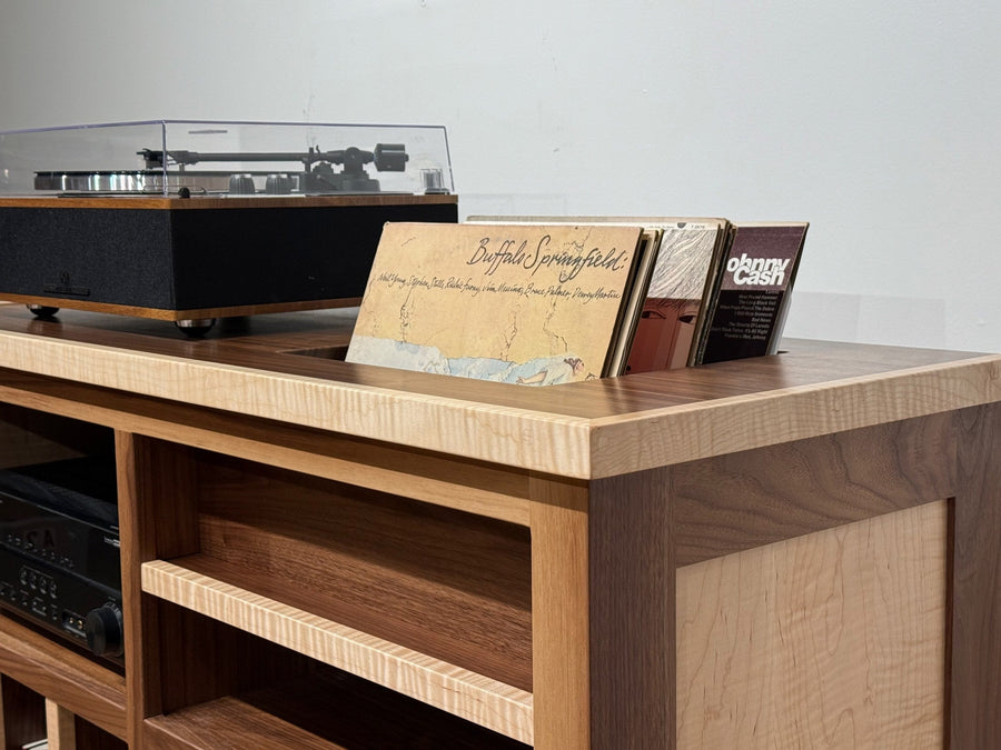 Flamed maple and walnut Record Console with a turntable on top and an album standing in the top slot
