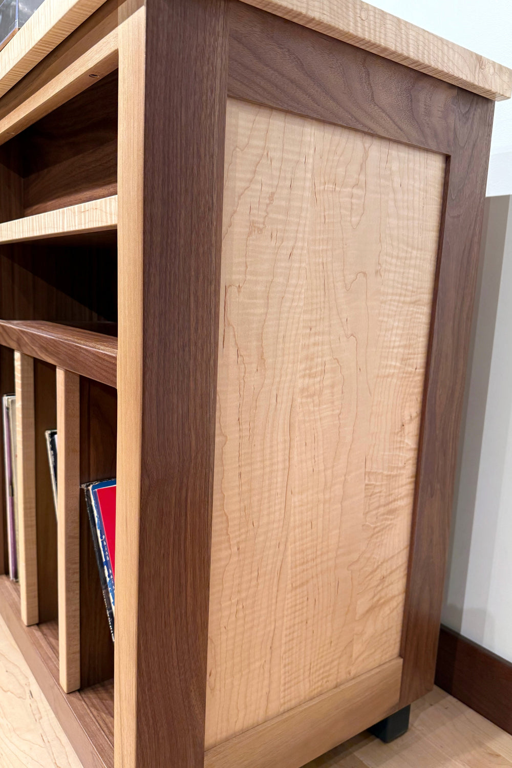 End view of the flamed maple and walnut Record Console showing the panelled side