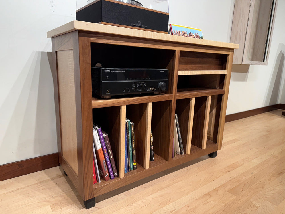 Front view of the flamed maple and walnut Record Console with a receiver and records below