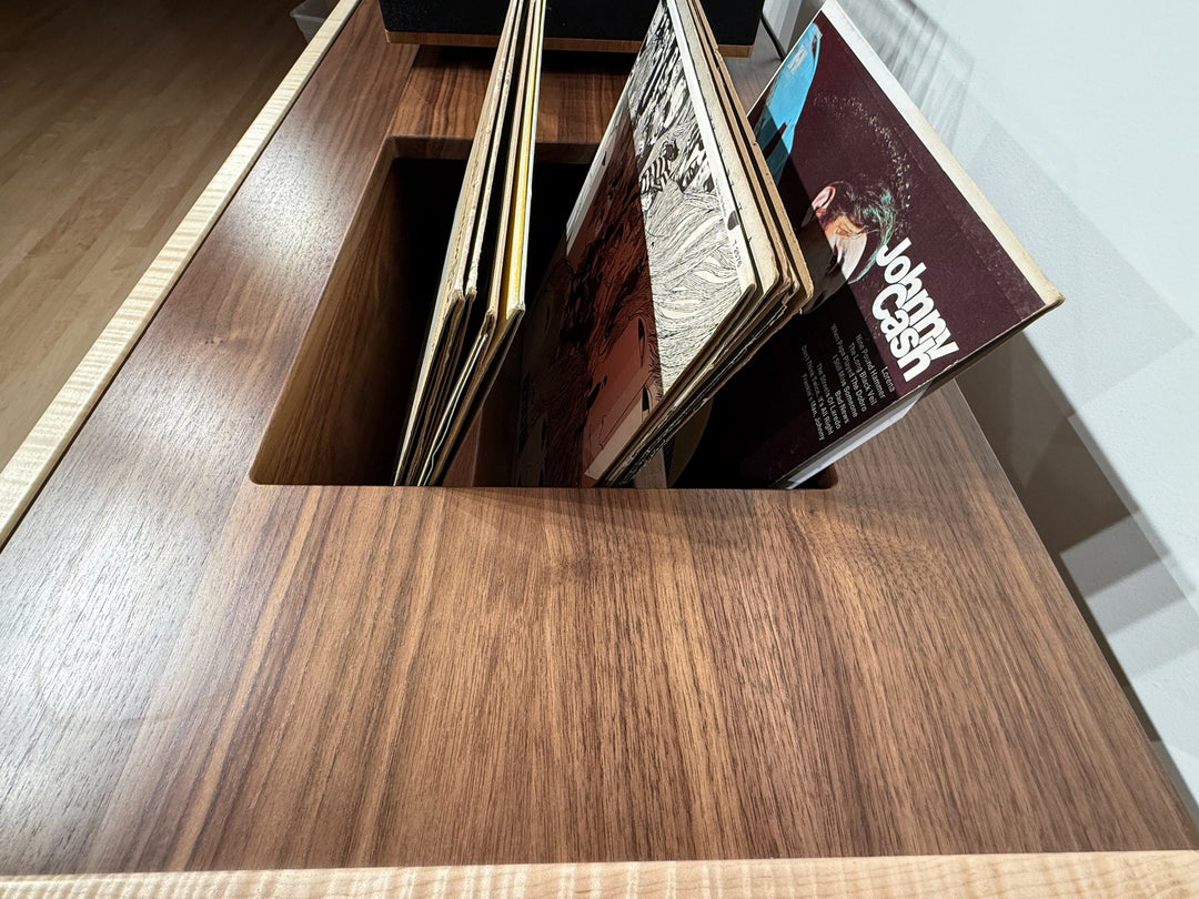 Records standing upright in the slot routed into the walnut top